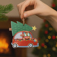 Load image into Gallery viewer, Festive dog themed Christmas ornament featuring a happy puppy riding in a red car with a Christmas tree on top. Designed with playful holiday colors and a cozy winter setting, this ornament brings a joyful pet themed touch to Christmas tree decor. Includes personalization options for name and year, making it a meaningful keepsake for dog lovers and pet families.
