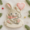 Load image into Gallery viewer, Decorative cookie cutter shaped like a rabbit with a pink heart balloon on a snowy background.
