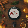 Load image into Gallery viewer, Personalized weightlifting and fitness Christmas ornament featuring a raised 3D front with bold circular design and red strength icons including boxing, gymnastics rings, and weightlifting. The ornament has a textured black outer rim and a flat 2D back for easy hanging. Includes a hanging kettlebell charm for added depth and movement. Hand-added personalization allows a name and year or family name. Photographed on a festive Christmas tree background with warm holiday lights.

