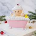 Load image into Gallery viewer, Decorative ornament of a baby in a bathtub with bubbles and a yellow rubber duck, set against a snowy background.
