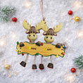 Load image into Gallery viewer, Decorative moose ornament with a nameplate on a snowy background
