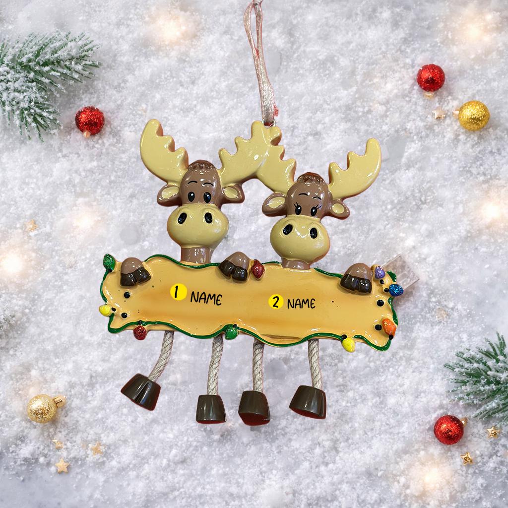 Decorative moose ornament with a nameplate on a snowy background