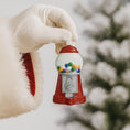 Load image into Gallery viewer, Red gumball machine ornament held by a gloved hand against a blurred natural background
