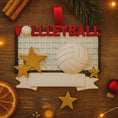 Load image into Gallery viewer, Volleyball-themed Christmas ornament on a wooden surface with decorations.
