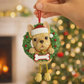 Load image into Gallery viewer, Dog Christmas ornament in a wreath with a Santa hat against a festive background

