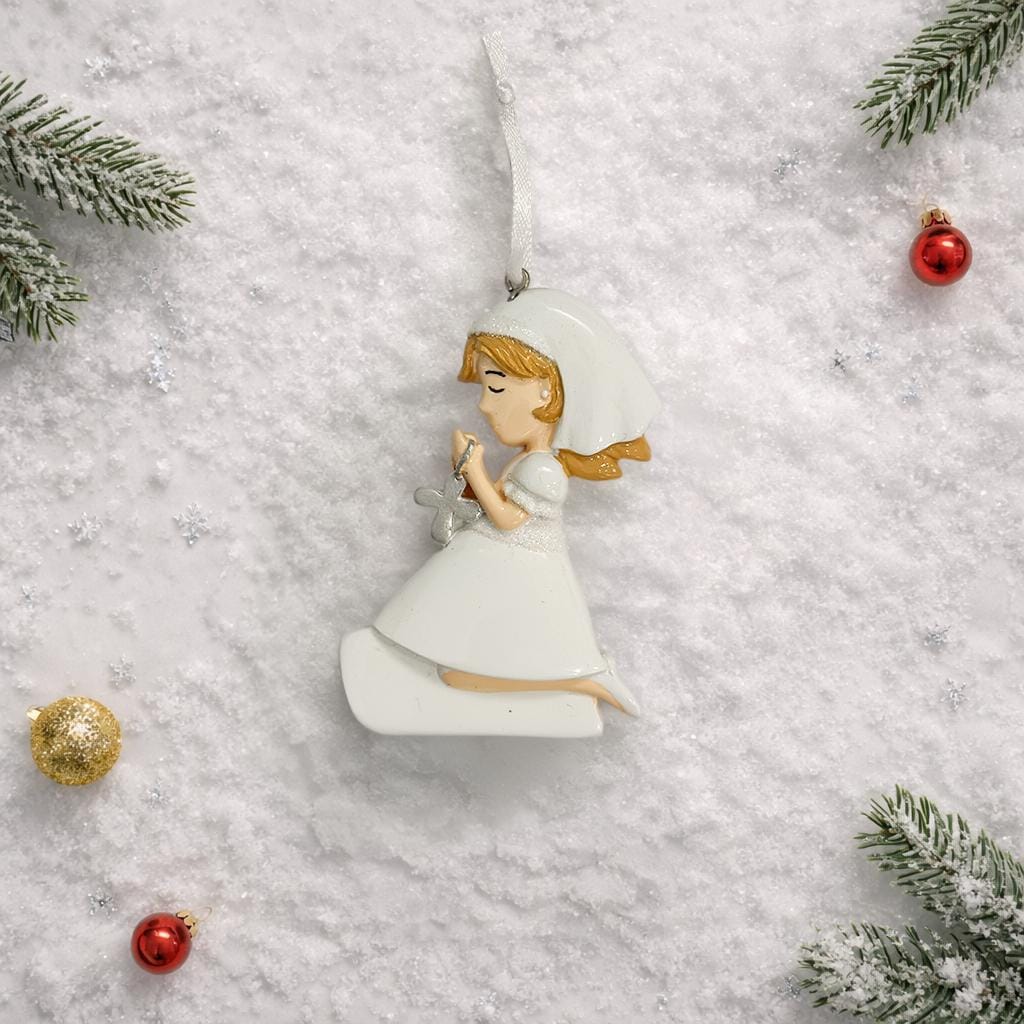 Decorative angel ornament on a snowy background with Christmas decorations.