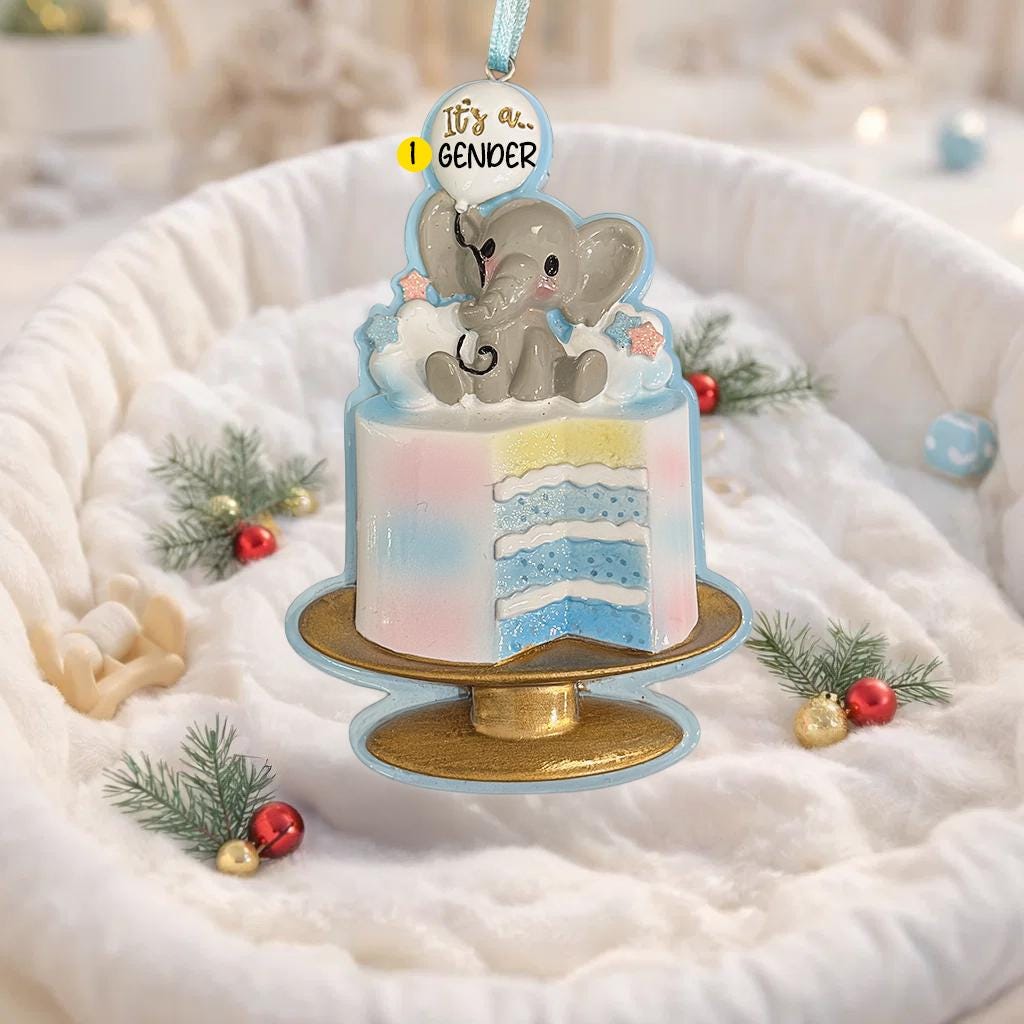 Decorative ornament with two elephants on a cake, featuring 'It's a...' text, on a soft white background.