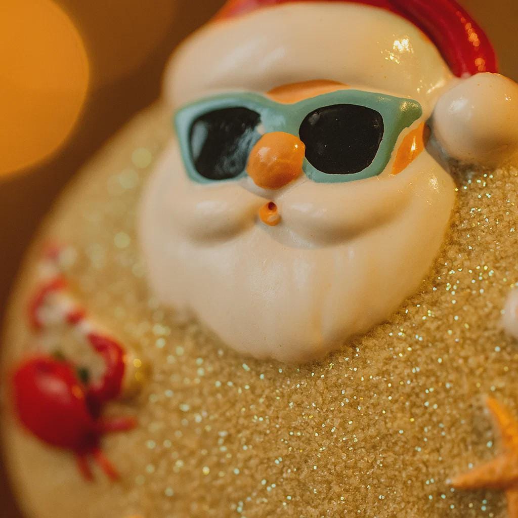 Sunny beach-themed figurine with sunglasses and a crab on sand
