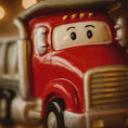Load image into Gallery viewer, Close-up of a red truck ornament with a face on a blurred background
