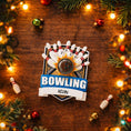 Load image into Gallery viewer, Bowling themed Christmas ornament featuring a raised 3D bowling ball striking detailed bowling pins on a shield style base. Personalized name and year placement is clearly visible on the front. Festive holiday styling with sports inspired details makes this ornament a perfect keepsake for bowling fans league players and Christmas tree decor.

