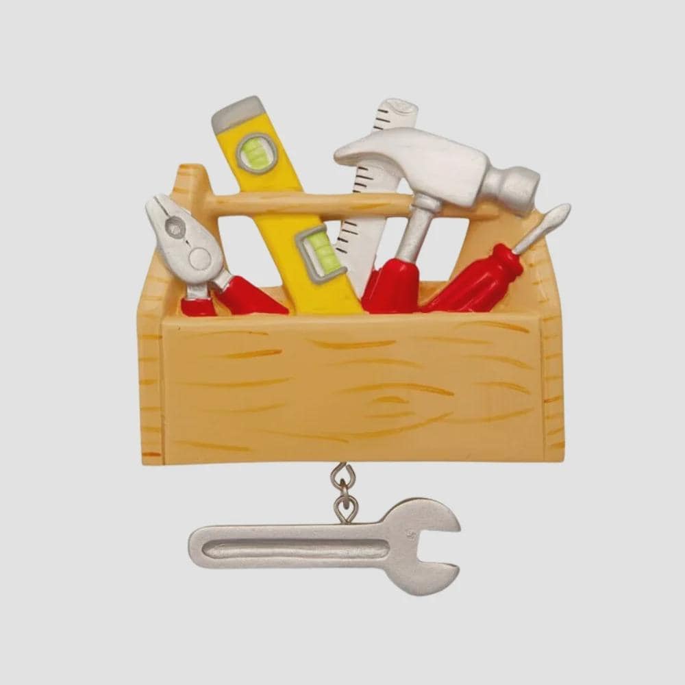 Personalized handyman ornament featuring a wooden style toolbox filled with tools including hammer wrench pliers and level. Custom name and year displayed on the front. Mostly 2D design with raised 3D tool details on the surface. Perfect Christmas ornament for handyman contractors mechanics and skilled trade workers.