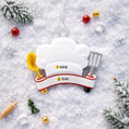Load image into Gallery viewer, Personalized chef Christmas ornament featuring a white chef hat design with a wooden spoon and metal spatula details. Customized with a name and year on the front banner. Glossy resin finish with clean white and red accents creates a fun and professional cooking themed holiday look. Mostly 2D ornament with raised 3D details on the front only, lightweight and perfect for Christmas tree decor or kitchen themed gifts.
