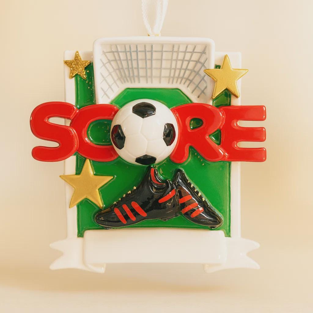 Soccer-themed ornament with 'SCORE' text, soccer ball, and boot on a beige background