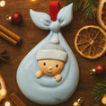 Load image into Gallery viewer, Decorative baby ornament in a cradle with festive background
