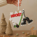 Load image into Gallery viewer, Hockey-themed ornament with skates, stick, and 'HOCKEY' text against a neutral background.
