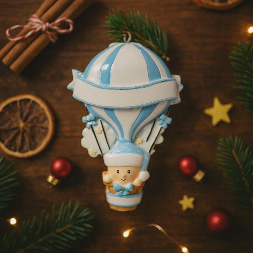 Personalized Baby Boy First Christmas Ornament designed as a charming 3D hot air balloon with a sweet baby in the basket below. The name is featured on the lower section and the year or Baby’s First Christmas message appears on the banner across the balloon. Soft blue and white tones, glitter accents, and raised dimensional details create a playful keepsake. Perfect for newborn boys, baby shower gifts, and celebrating a baby’s first holiday season.