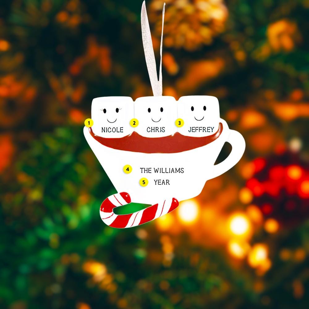 Decorative Christmas ornament shaped like a teacup with marshmallows and candy cane, against a festive background.