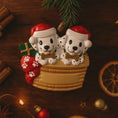 Load image into Gallery viewer, Personalized Christmas dog ornament featuring two adorable dalmatian puppies sitting together on a cozy basket, each wearing a Santa hat and holding a bone. Both puppies can be customized with names, while the front of the basket is personalized with a year or family name. Decorated with festive details like a stocking, gift box, and holiday accents, this ornament has a raised 3D front and smooth finish, making it perfect for dog lovers, couples, families, and Christmas tree decor.

