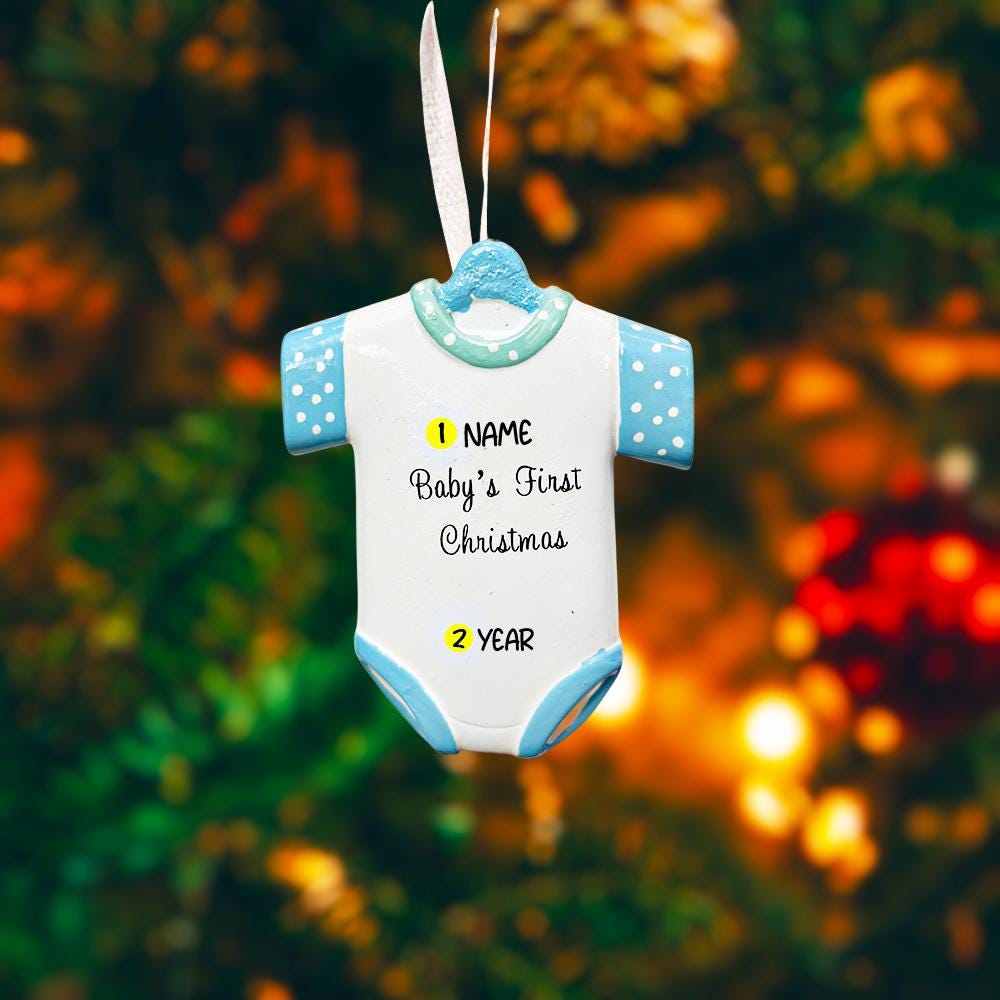 Personalized Baby’s First Christmas Ornament designed as a sweet baby bodysuit with soft blue polka dot sleeves and trim. This ornament features a raised 3D front with textured details and dimensional edges for a charming keepsake look. The baby’s name is added at the top and the year below, creating a meaningful newborn memory gift. Perfect for baby boy first Christmas, newborn celebration, holiday tree decor, and special family milestone ornament.