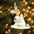 Load image into Gallery viewer, Wedding cake topper ornament with a couple holding hands, against a festive background.
