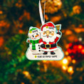 Load image into Gallery viewer, Personalized Santa and snowman ornament featuring a classic Christmas design with Santa holding a bell and a smiling snowman standing beside him. The ornament includes custom name and year personalization on the figures and base. Finished with a smooth glossy surface and detailed 3D front, it is designed for easy hanging on a Christmas tree. Perfect for festive holiday decor, family keepsakes, and seasonal gift giving.
