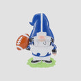 Load image into Gallery viewer, Personalized football gnome Christmas ornament featuring a blue and white gnome character wearing a football helmet and holding a football, customizable name area on the front body and customizable year area on the football, glossy finish with raised 3D front details and flat 2D back, white hanging ribbon, displayed on a snowy football field themed holiday background with pine branches and festive decorations.
