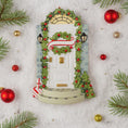 Load image into Gallery viewer, Decorative door with wreath, ornaments, and Christmas decorations on a textured surface.
