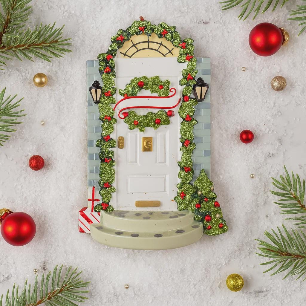 Decorative door with wreath, ornaments, and Christmas decorations on a textured surface.