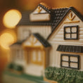 Load image into Gallery viewer, Decorative house ornament with a blurred warm background
