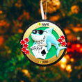Load image into Gallery viewer, Personalized poker ornament featuring a cool shark character wearing sunglasses with playing cards and red casino chips. Designed in a round ornament style with a glossy finish. Includes free handwritten personalization with one name and year displayed on the front. Shown hanging with a ribbon in a festive holiday setting with greenery snow and seasonal decor. 3D raised front and flat back design perfect for Christmas trees and gifts for poker players casino lovers and card game fans.
