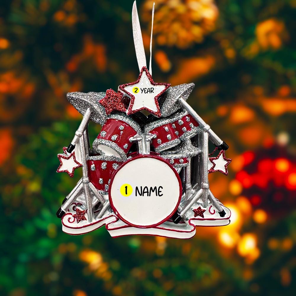Personalized drum set ornament featuring a detailed red and silver drum kit with cymbals and star accents. Customizable with one name and a year. Crafted from resin with a glossy finish, featuring 3D raised front drum elements and a flat 2D back for balanced hanging. Finished with a satin ribbon. Designed for drummers musicians band members and music themed Christmas tree decor.