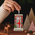 Load image into Gallery viewer, Decorative ornament with 'Our New Home' text, held by a hand against a festive background.
