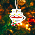 Load image into Gallery viewer, Christmas ornament with names on a cup and marshmallows against a blurred Christmas tree background
