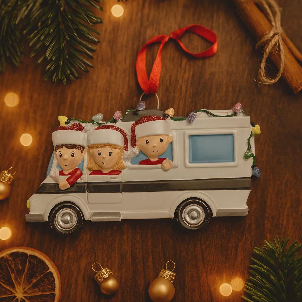 Christmas ornament of a family in a car with children wearing Santa hats on a wooden background.