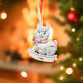 Load image into Gallery viewer, A glossy resin baby girl llama ornament features a white smiling llama with soft pink accents, raised textured fur details, pink bow and scarf elements, glitter highlights, and a smooth painted cartoon style finish, styled with warm holiday lights and nursery themed props, handwritten personalization showing the baby name on the front banner and the year placed on the llama body, designed as a mostly 2D ornament with raised 3D details on the front only.
