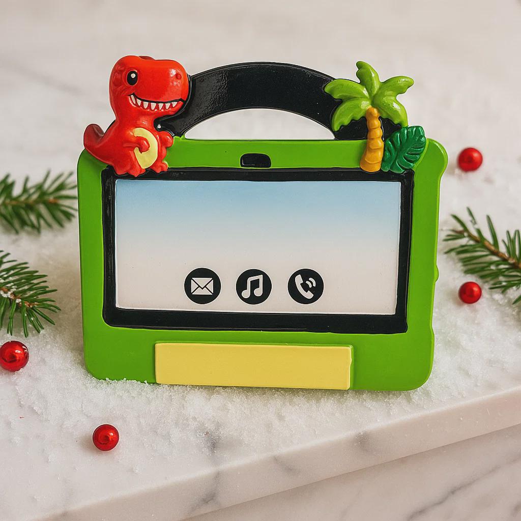 Children's tablet ornament with dinosaur design on a snowy background