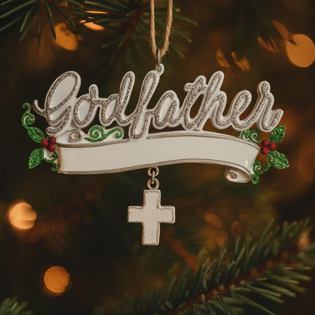 Decorative ornament with 'Godfather' text hanging on a Christmas tree.