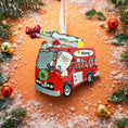 Load image into Gallery viewer, Christmas ornament of a red fire truck with Santa Claus driving, surrounded by festive decorations.
