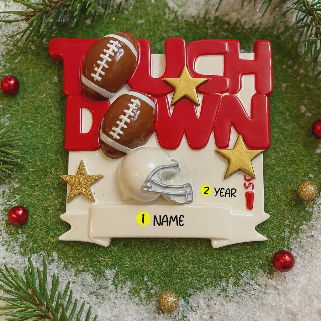 Decorative Christmas ornament with footballs, helmet, and 'Touch Down' text on a green background.