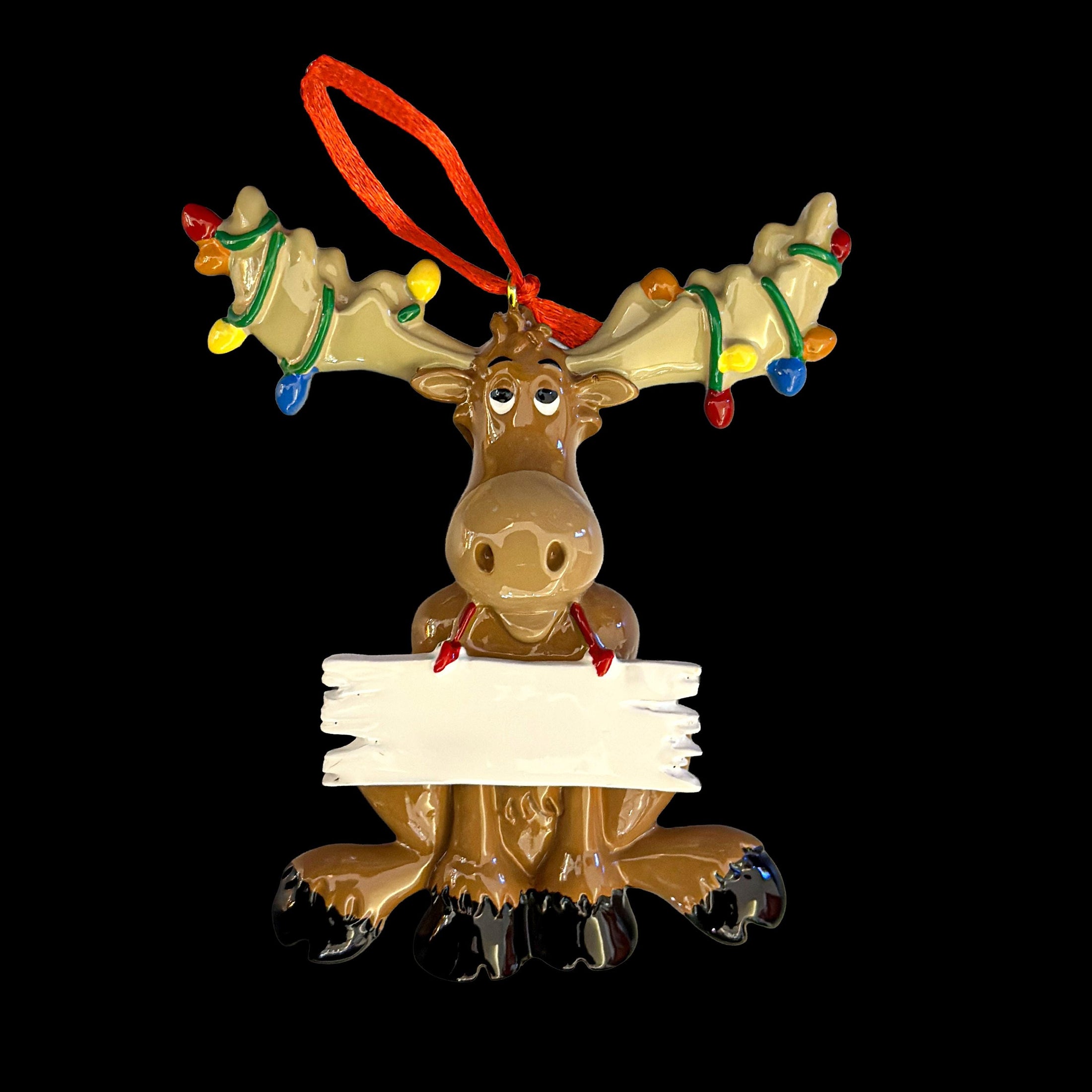 Decorative reindeer ornament with lights and a blank sign on a black background