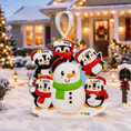 Load image into Gallery viewer, Personalized Christmas ornament with penguins and a snowman in front of a decorated house.
