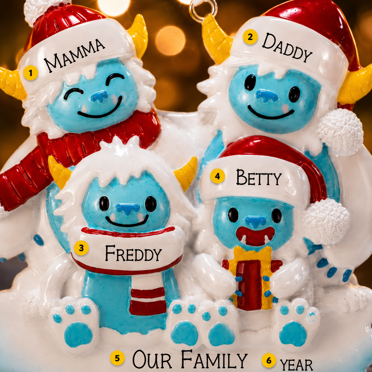 Christmas-themed family ornament with four characters labeled Mamma, Daddy, Freddy, and Betty against a blurred festive background.