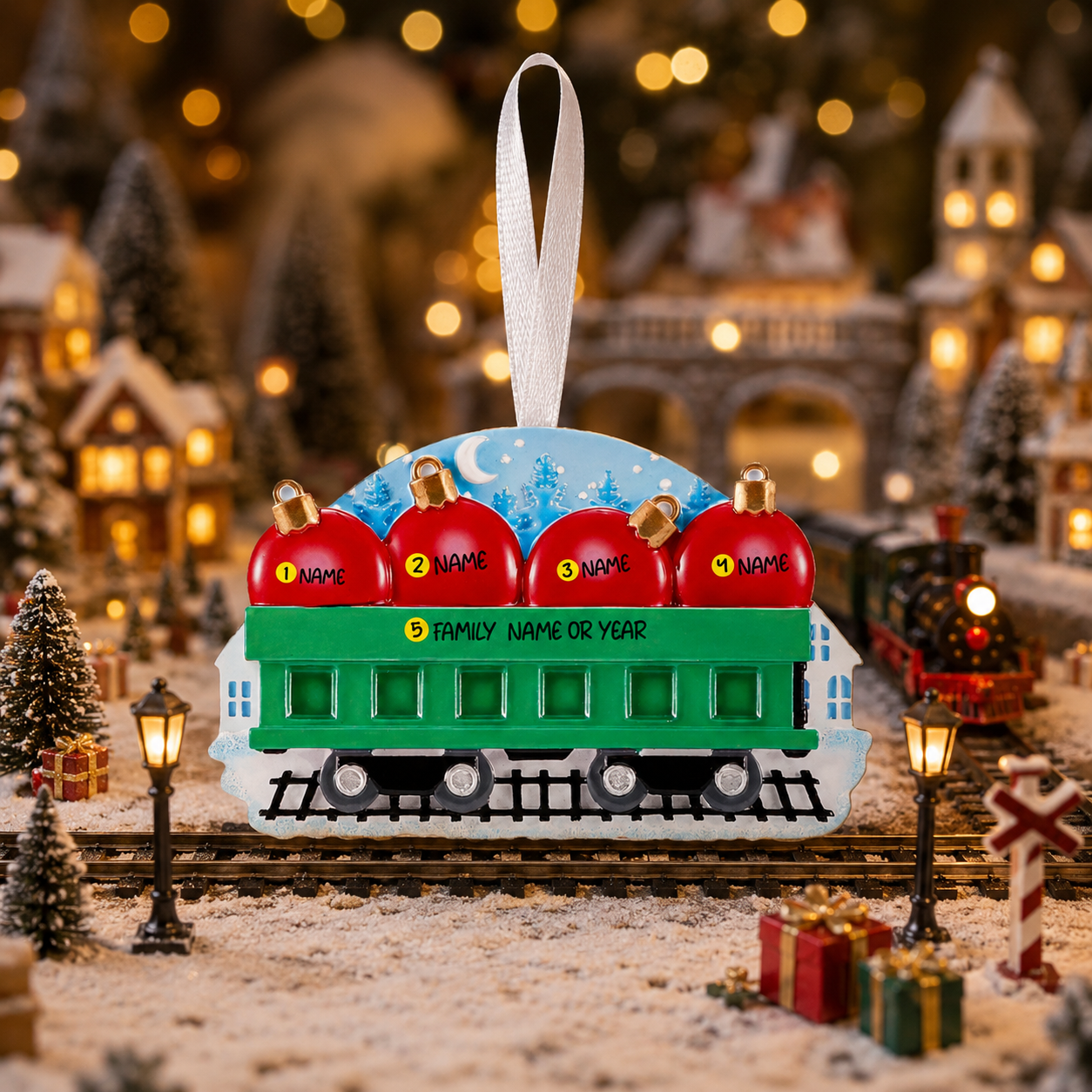 Decorative train ornament with red apples on a Christmas village background