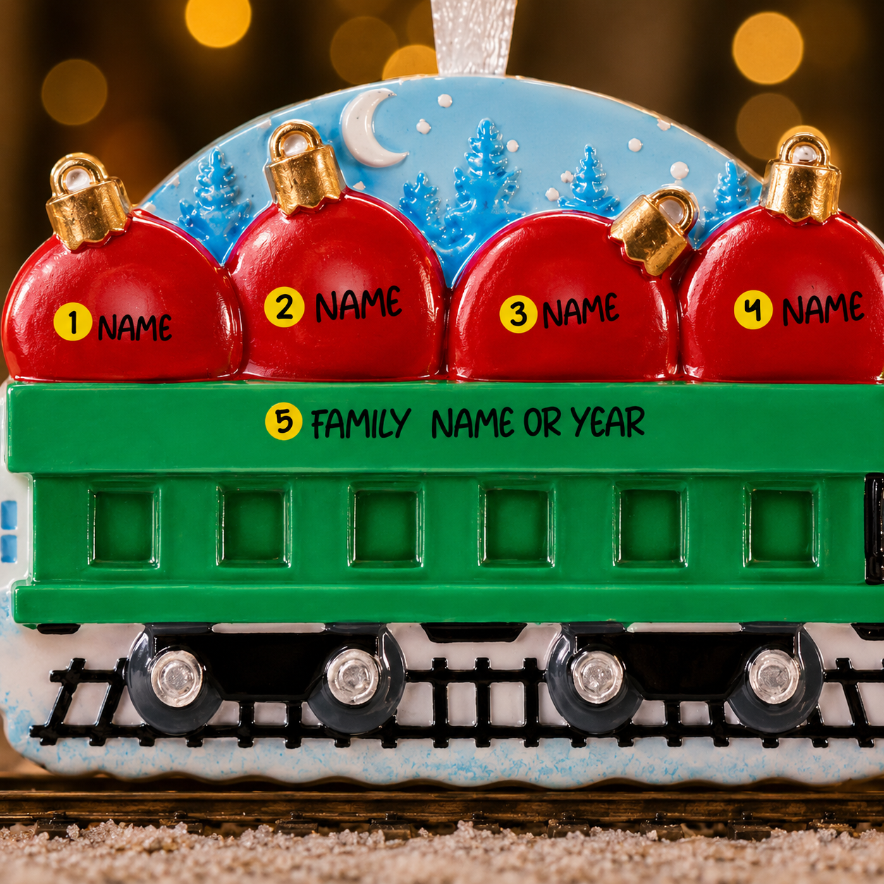 Decorative train ornament with red炸弹-shaped cars and a green base, set against a blurred background.