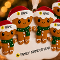 Load image into Gallery viewer, Personalized gingerbread family ornament with customizable names or year on a blurred warm background.
