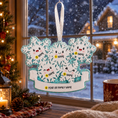 Load image into Gallery viewer, Decorative ornament with snowflakes and names on a festive background
