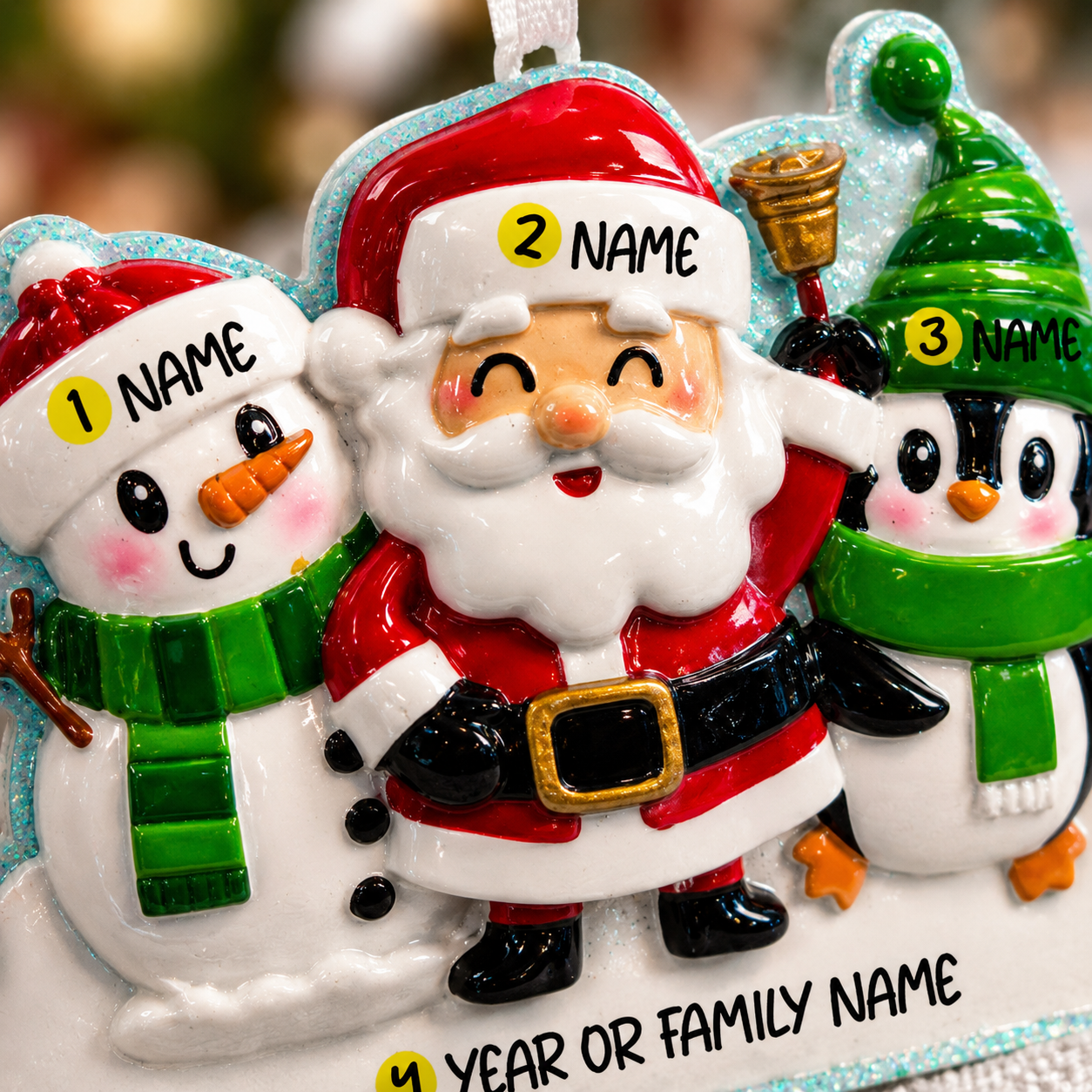 Decorative Christmas ornament with Santa Claus, snowman, and penguin, each with 'NAME' labels.