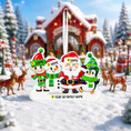 Load image into Gallery viewer, Christmas ornament with Santa Claus and elves in a snowy village scene
