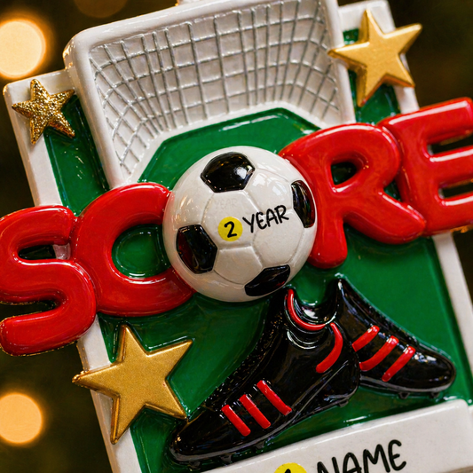 Soccer-themed ornament with a ball, boot, and 'Score' text on a green background.