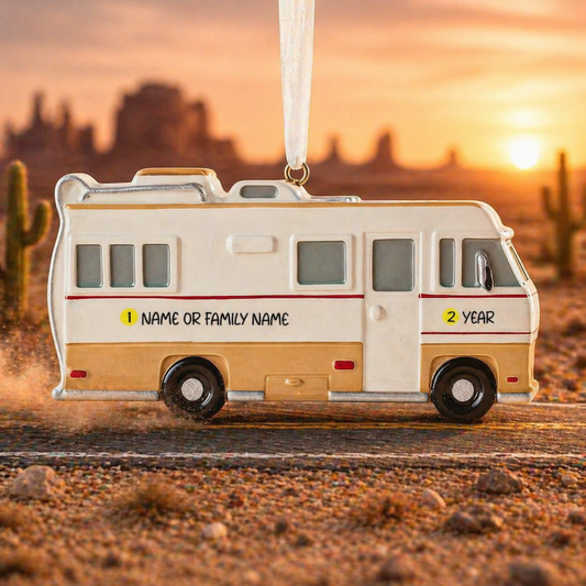 RV-shaped ornament with customizable text against a desert sunset background